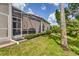 Landscaped backyard with lush greenery and a screened patio at 1711 Starling Dr # 1711, Sarasota, FL 34231