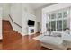 Spacious living room with hardwood floors, fireplace, and access to a balcony at 1711 Starling Dr # 1711, Sarasota, FL 34231