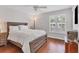 Bright bedroom featuring hardwood floors and a rustic wooden bed frame at 1711 Starling Dr # 1711, Sarasota, FL 34231