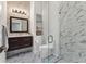 Modern bathroom with dark vanity, hexagon tile, and a glass enclosed shower at 1711 Starling Dr # 1711, Sarasota, FL 34231