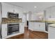 Modern kitchen with white cabinets, granite counters, and stainless steel appliances at 1711 Starling Dr # 1711, Sarasota, FL 34231