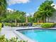 Inviting community pool with lounge chairs and patio tables at 4212 126Th W St # 409, Cortez, FL 34215