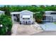 Quaint mobile home with covered awning, landscaping, and seating area at 3333 26Th E Ave # 1026, Bradenton, FL 34208