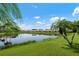 Stunning lakefront view with lush landscaping at 4140 Reflections Pkwy, Sarasota, FL 34233