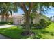 Single story home with a large oak tree and attached garage at 4140 Reflections Pkwy, Sarasota, FL 34233