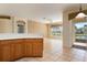 Kitchen with wood cabinets and view to living area at 4140 Reflections Pkwy, Sarasota, FL 34233