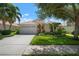 Single-story home with attached garage and manicured lawn at 4140 Reflections Pkwy, Sarasota, FL 34233