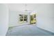 Well-lit bedroom featuring sliding glass doors opening to the backyard at 4223 Murfield E Dr, Bradenton, FL 34203