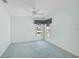 Spacious bedroom with light blue walls, carpeting, and a window offering a view at 4223 Murfield E Dr, Bradenton, FL 34203