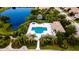 Aerial view of community pool, lake, clubhouse and landscaping creating resort-style living at 4830 Maymont Park Cir, Bradenton, FL 34203