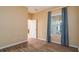 Bedroom with beautiful wood floors and a window with striped blue curtains, creating a cozy atmosphere at 4830 Maymont Park Cir, Bradenton, FL 34203