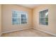 Bedroom featuring carpeted floors and two windows bringing in natural light at 4830 Maymont Park Cir, Bradenton, FL 34203