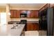 Modern kitchen features wood cabinetry, tile backsplash, and stainless steel appliances at 4830 Maymont Park Cir, Bradenton, FL 34203