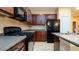 Modern kitchen features stainless steel appliances, dark wood cabinetry, and tiled flooring at 4830 Maymont Park Cir, Bradenton, FL 34203
