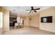 Open-concept living room with tiled floors, dark wood cabinetry, and a view to the dining room at 4830 Maymont Park Cir, Bradenton, FL 34203