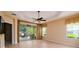 Spacious bedroom features tiled floors, ceiling fan, natural light, and sliding doors leading to a screened patio at 4830 Maymont Park Cir, Bradenton, FL 34203