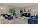 Bright living room featuring plush blue sofas and a view of the backyard at 9044 Misty Creek Dr, Sarasota, FL 34241