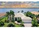 Waterfront home boasts lush landscaping, a bright exterior, and a tile roof at 811 Riviera Dunes Way, Palmetto, FL 34221