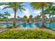 Large resort-style pool with ample lounge chairs and palm trees at 25081 Spartina Dr, Venice, FL 34293