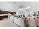 Open concept kitchen and living area with dark cabinets and island at 25081 Spartina Dr, Venice, FL 34293