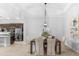 Elegant dining room adjacent to the kitchen with modern lighting at 25081 Spartina Dr, Venice, FL 34293