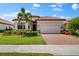 One-story house with landscaped yard and brick driveway at 25081 Spartina Dr, Venice, FL 34293