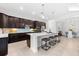 Modern kitchen with dark cabinetry, a large island, and stainless steel appliances at 25081 Spartina Dr, Venice, FL 34293