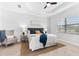 Bright bedroom with a comfortable bed and sitting area at 25081 Spartina Dr, Venice, FL 34293