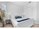 Bright bedroom with white furniture and blue accents at 25081 Spartina Dr, Venice, FL 34293