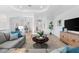 Spacious living room with neutral decor and views to the dining area at 25081 Spartina Dr, Venice, FL 34293