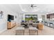 Living Room with sectional sofa and large window overlooking backyard at 25081 Spartina Dr, Venice, FL 34293