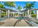 Relaxing hot tub surrounded by lounge chairs and palm trees at 25081 Spartina Dr, Venice, FL 34293