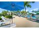 Poolside lounge area with blue umbrellas and comfortable seating at 25081 Spartina Dr, Venice, FL 34293