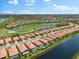 Aerial view of home with pool in a waterfront community at 25081 Spartina Dr, Venice, FL 34293