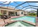 Inviting pool and spa with a screened enclosure at 25081 Spartina Dr, Venice, FL 34293