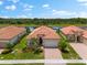 One story house with a tile roof and lush landscaping at 25081 Spartina Dr, Venice, FL 34293