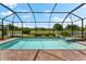 Inviting screened pool and spa with a view of the golf course at 25081 Spartina Dr, Venice, FL 34293
