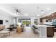 Open concept kitchen and living area with modern cabinetry and a view to the outdoors at 25081 Spartina Dr, Venice, FL 34293