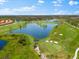 Aerial view of upscale community with golf course and lake at 25081 Spartina Dr, Venice, FL 34293