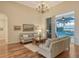 Spacious living room with hardwood floors, light walls, and sliding glass doors to the patio at 811 Riviera Dunes Way, Palmetto, FL 34221