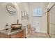 Relaxing bathroom with copper sink and walk-in shower at 811 Riviera Dunes Way, Palmetto, FL 34221