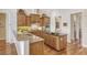 Island kitchen with granite countertops, wood cabinets, and stainless steel appliances at 811 Riviera Dunes Way, Palmetto, FL 34221