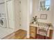 Laundry room with desk and access to additional storage at 811 Riviera Dunes Way, Palmetto, FL 34221