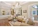 Bright living room with hardwood floors, comfortable seating, and sliding glass doors to the outdoors at 811 Riviera Dunes Way, Palmetto, FL 34221