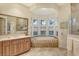 Bathroom with soaking tub and large vanity at 811 Riviera Dunes Way, Palmetto, FL 34221