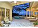 Relaxing covered patio with pool and spa overlooking scenic water views at 811 Riviera Dunes Way, Palmetto, FL 34221