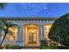 Elegant home exterior featuring a grand entrance and lush landscaping at 811 Riviera Dunes Way, Palmetto, FL 34221