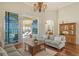 Living room with hardwood floors, sofas, coffee table and pool access at 811 Riviera Dunes Way, Palmetto, FL 34221