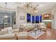 Gathering room with hardwood floors, comfortable seating, and water views at night at 811 Riviera Dunes Way, Palmetto, FL 34221