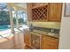 Wet bar with granite countertop, wine rack, and mini-refrigerator, opens to the pool area at 811 Riviera Dunes Way, Palmetto, FL 34221